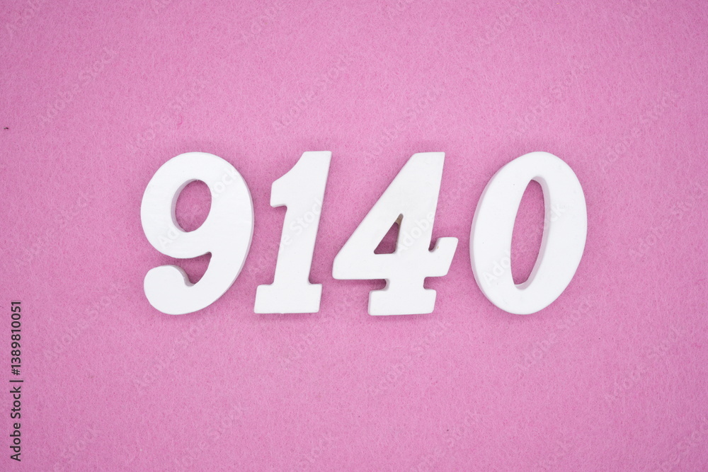 The numbers are made of white painted wood and placed on a pink paper background. The numbers are made of white painted wood and placed on a pink paper background.
