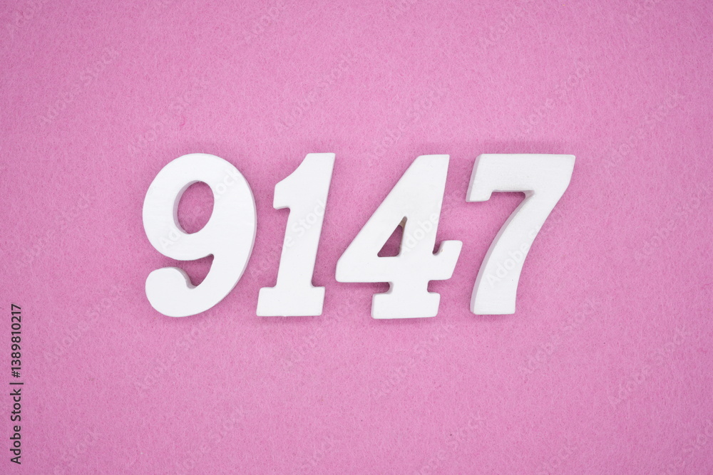 The numbers are made of white painted wood and placed on a pink paper background. The numbers are made of white painted wood and placed on a pink paper background.