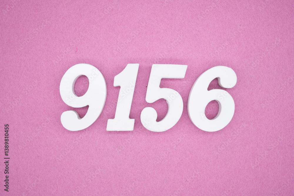 The numbers are made of white painted wood and placed on a pink paper background. The numbers are made of white painted wood and placed on a pink paper background.