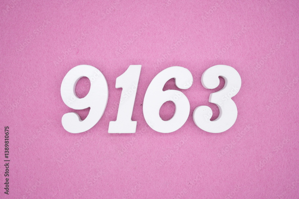The numbers are made of white painted wood and placed on a pink paper background. The numbers are made of white painted wood and placed on a pink paper background.