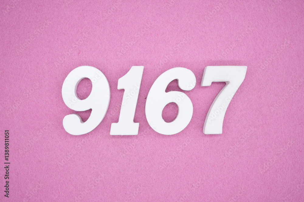The numbers are made of white painted wood and placed on a pink paper background. The numbers are made of white painted wood and placed on a pink paper background.