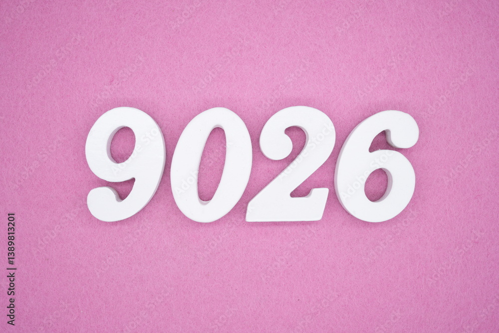 The numbers are made of white painted wood and placed on a pink paper background. The numbers are made of white painted wood and placed on a pink paper background.