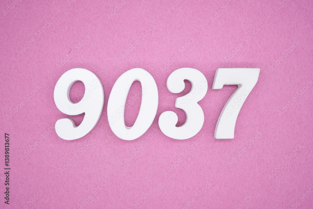 The numbers are made of white painted wood and placed on a pink paper background. The numbers are made of white painted wood and placed on a pink paper background.