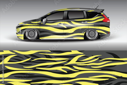 Stylishly modified car with striking yellow and black striped design parked on a smooth gradient background