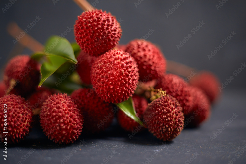 Fresh red lychee fruits with leaves Fresh red lychee fruits with leaves