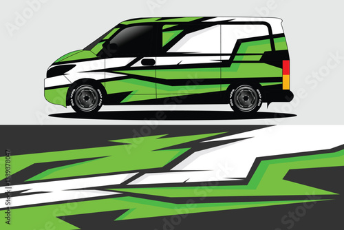 Van with dynamic green and black wrap design parked against a minimalist gray backdrop