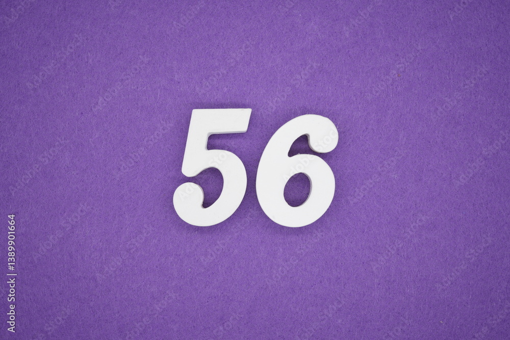 The numbers are made of white painted wood placed on a purple paper background. The numbers are made of white painted wood placed on a purple paper background.