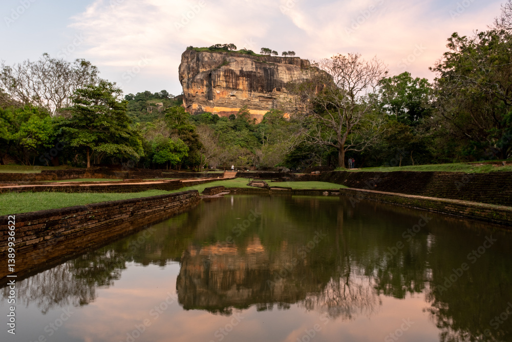 View of the Lion Rock Fortress with reflection in water in Sigiriya, Sri Lanka. View of the Lion Rock Fortress with reflection in water in Sigiriya, Sri Lanka.