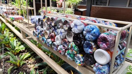 Colorful Plastic Bottle Ecobricks Filled with Non-Organic Waste for Creative Recycling Solution and Sustainable Household Waste Management

