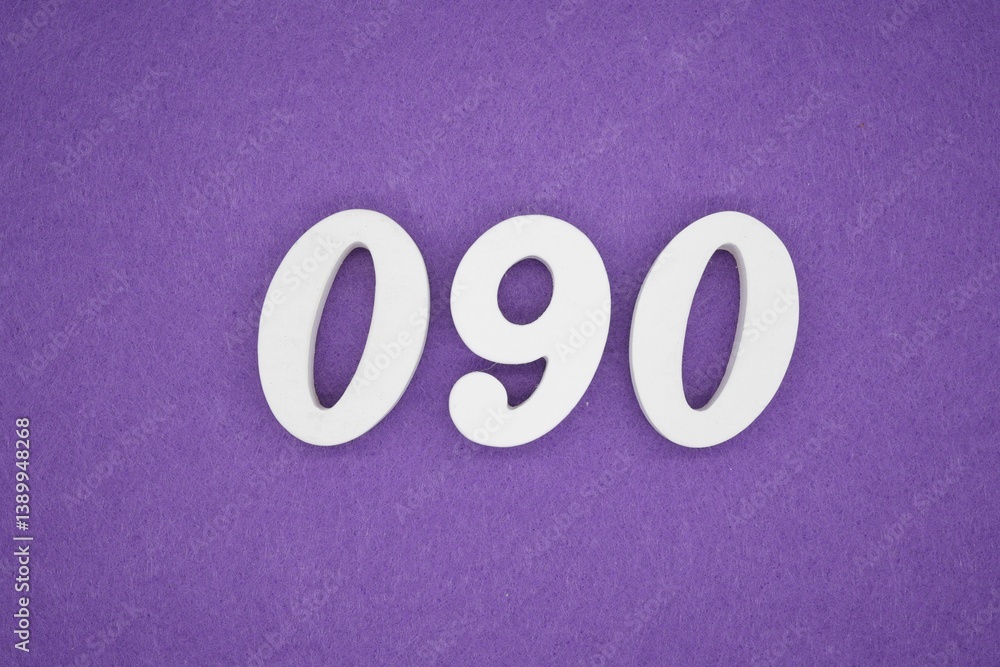 The numbers are made of white painted wood placed on a purple paper background. The numbers are made of white painted wood placed on a purple paper background.