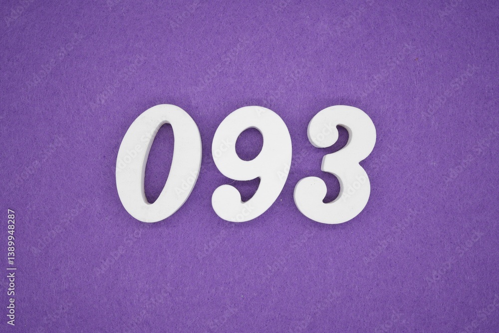 The numbers are made of white painted wood placed on a purple paper background. The numbers are made of white painted wood placed on a purple paper background.