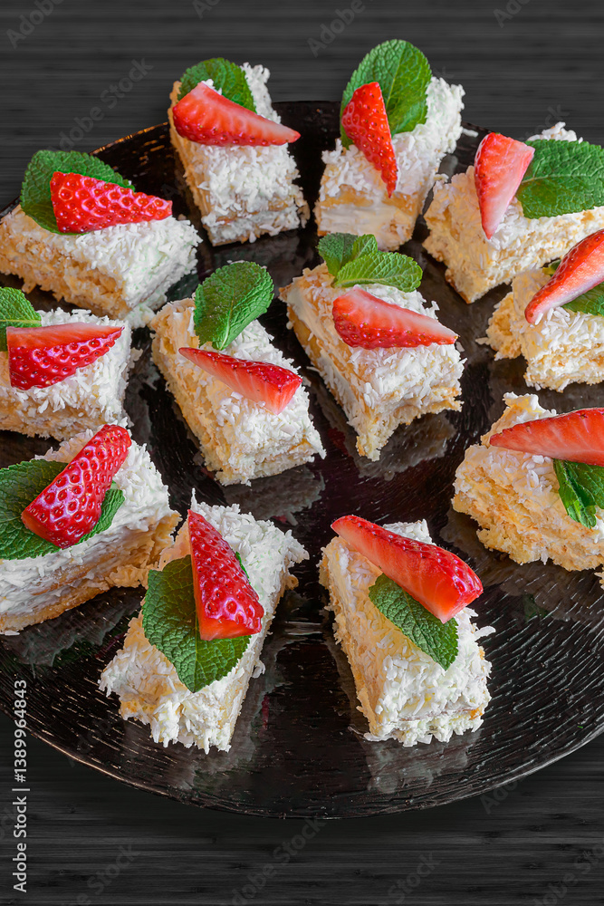 coconut cream tartlets with strawberries and mint leaves