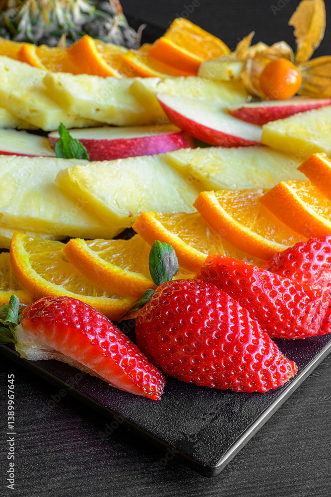 fruit platter with strawberries, oranges, pineapple and apples