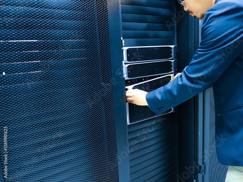 Person Adjusts Server Equipment in Data Center