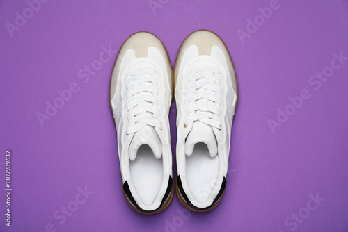 Wallpaper Mural Pair of stylish sneakers on purple background, flat lay. Casual shoes Torontodigital.ca