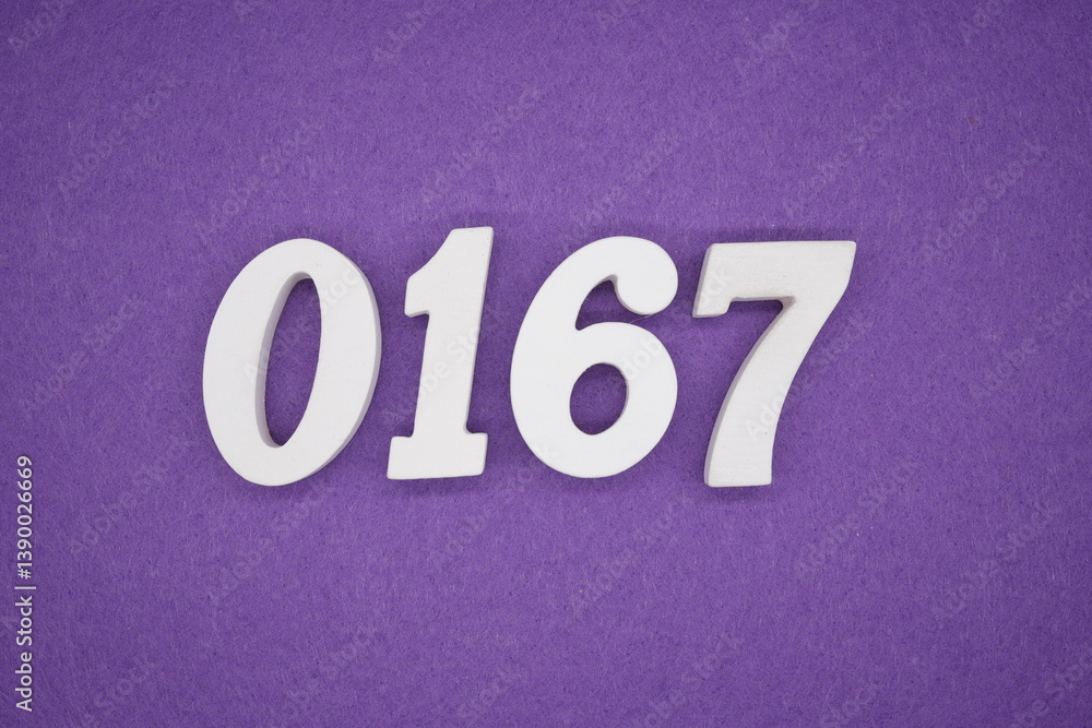 The numbers are made of white painted wood placed on a purple paper background. The numbers are made of white painted wood placed on a purple paper background.