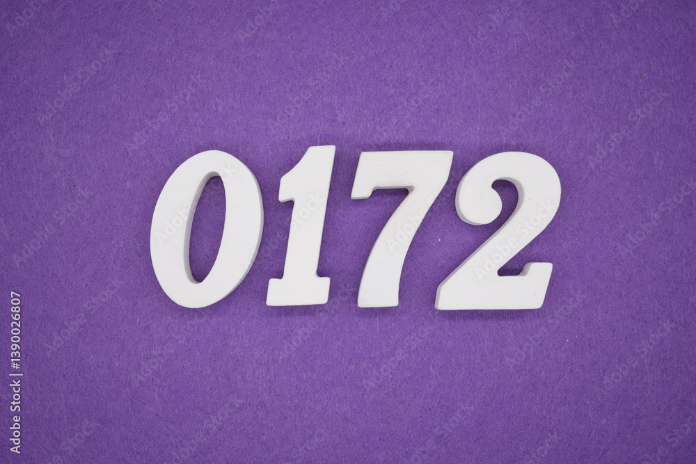 The numbers are made of white painted wood placed on a purple paper background. The numbers are made of white painted wood placed on a purple paper background.