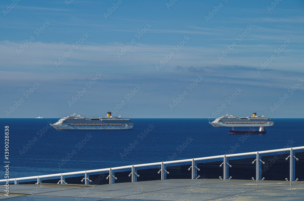 Mega family cruiseship cruise ship liner Favolosa and Fortuna anchored offshore of Civitavecchia Rome, Italy before reactived after Covid pandemic with other vessels in port and coastline