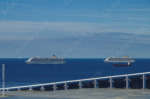 Obraz na płótnie Mega family cruiseship cruise ship liner Favolosa and Fortuna anchored offshore of Civitavecchia Rome, Italy before reactived after Covid pandemic with other vessels in port and coastline w salonie