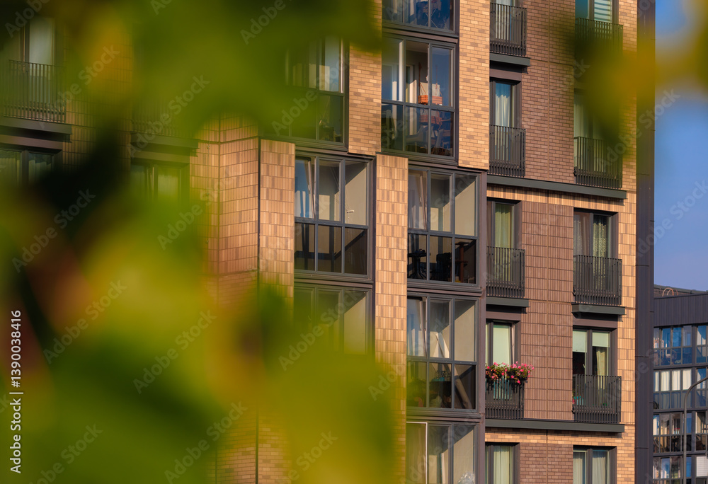 Fototapeta premium City view on a sunny day. Modern buildings, walls and windows.