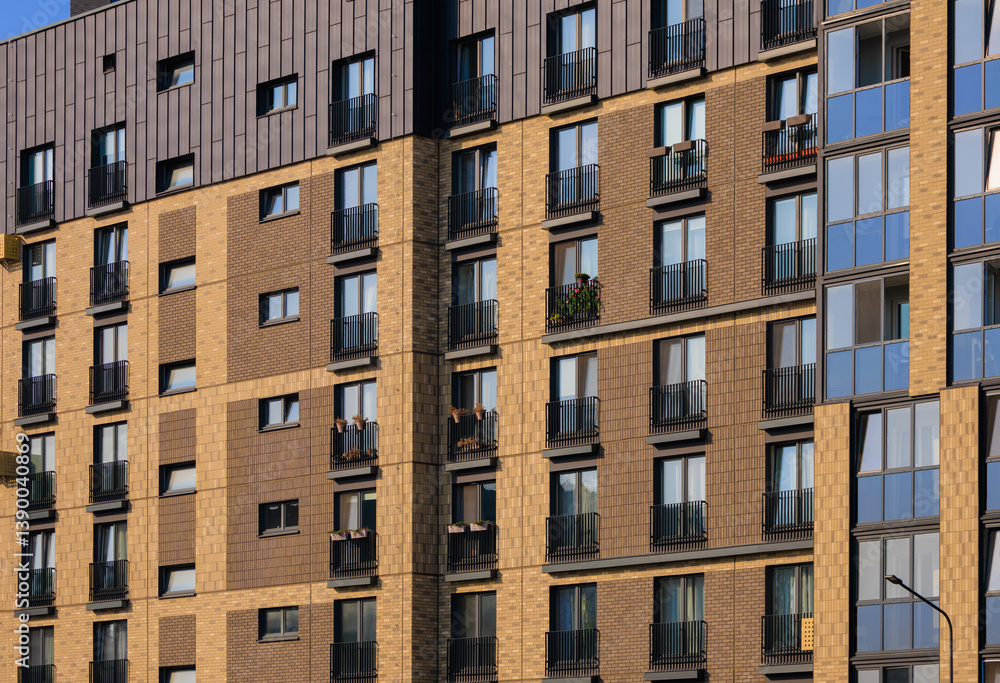 Fototapeta premium City view on a sunny day. Modern buildings, walls and windows.