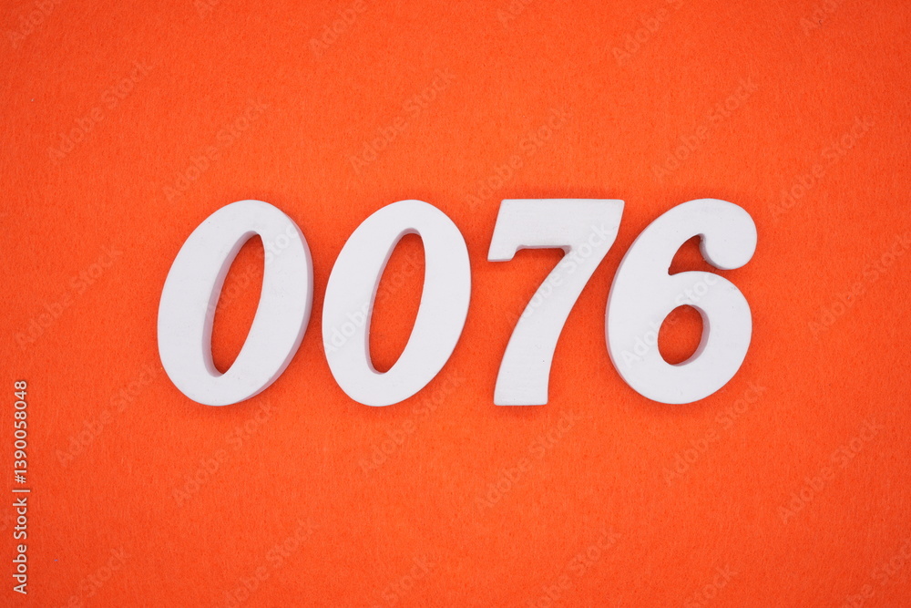 The numbers are made of white painted wood placed on an orange paper background. The numbers are made of white painted wood placed on an orange paper background.