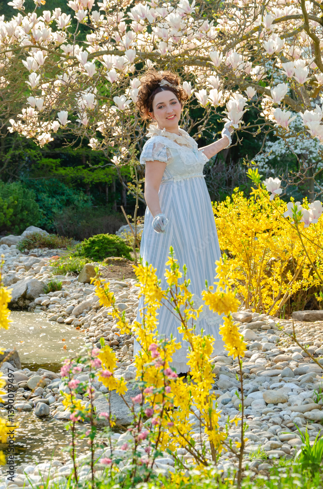 Romantic spring scene with a woman in historical attire in a botanical garden. Romantic spring scene with a woman in historical attire in a botanical garden.
