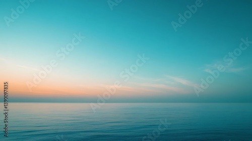Tranquil ocean sunset with soft teal and orange hues.