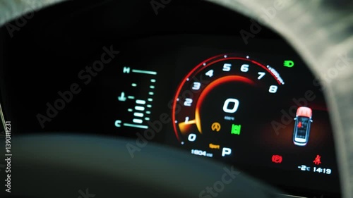 Arrow of tachometer in car shows number of engine revolutions per second. Tachometer of a new car with moving arrow on the gauge on dashboard, closeup view