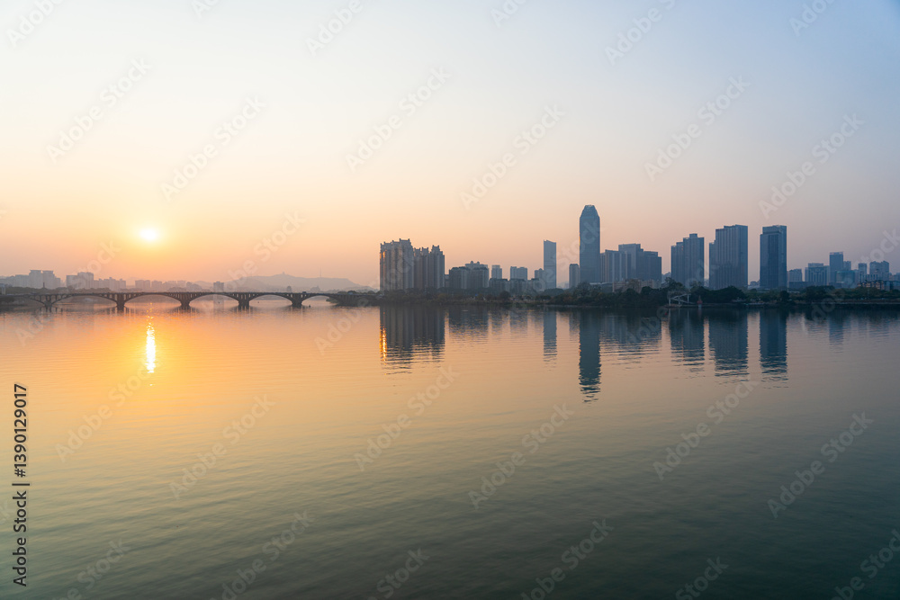 Sunset scenery of Jiangbei Business CBD and Dongjiang Bridge in Huizhou, China Sunset scenery of Jiangbei Business CBD and Dongjiang Bridge in Huizhou, China