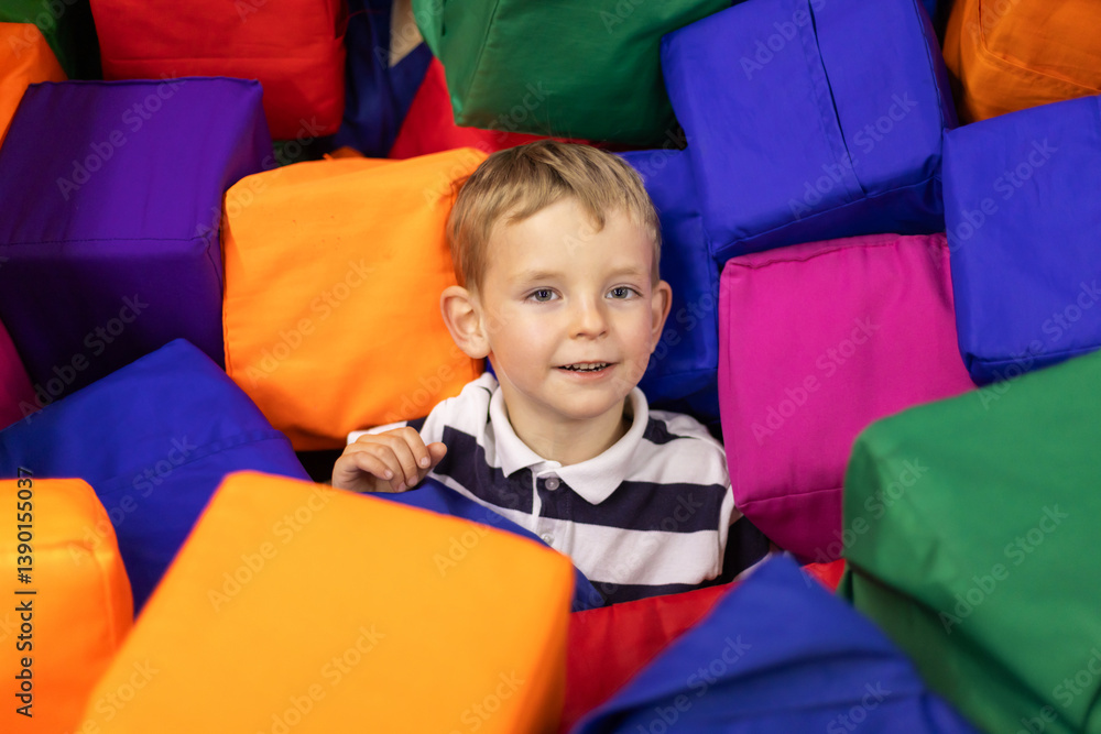 Boy playing in colorful foam pit