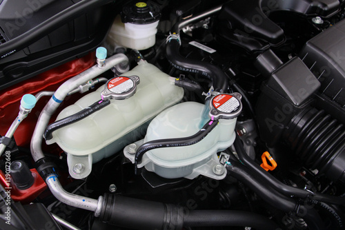 Car radiator cap in the engine room. Radiator cap with warning label in a car engine. car maintenance and repair concept. components of car concept.