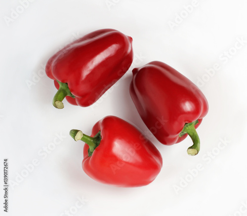Three red peppers on a white background. Group. Top view 