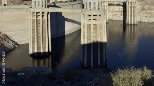 Intake towers stand tall at Hoover Dam, reflecting the impressive engineering against the backdrop of the arid Arizona landscape