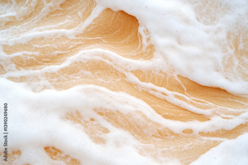 Obraz premium Soft waves create mesmerizing dance of foam and sandy hues, evok