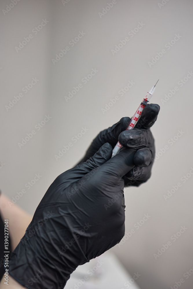 Gloved Hands Holding Syringe with Needle in Focus for Medical Injection Professional Use Concept