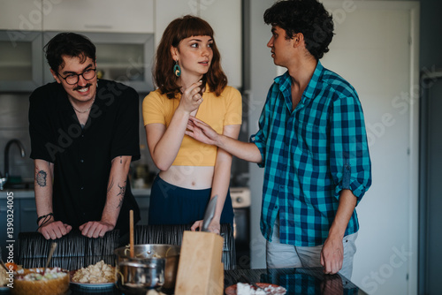 Obraz na płótnie Three friends gather in a modern kitchen, enjoying casual conversation and laughter. The scene captures a friendly and relaxed atmosphere, highlighting camaraderie and togetherness. w salonie
