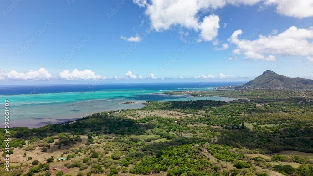 Tropical paradise shoreline of Mauritius with stunning blue gradient waters and coastal terrain and mountain peak. Tropical paradise shoreline of Mauritius with stunning blue gradient waters and coastal terrain and mountain peak.