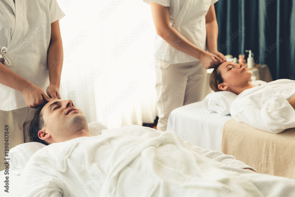 Obraz premium Caucasian couple enjoying relaxing anti-stress head massage and pampering facial beauty skin recreation leisure in dayspa modern light ambient at luxury resort or hotel spa salon. Quiescent