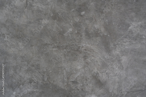 Textured gray concrete wall with a rough, industrial finish, ideal for modern design backgrounds.