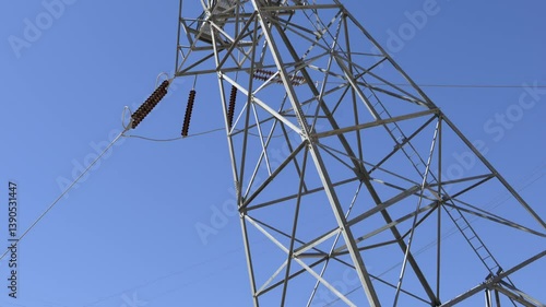 High voltage power lines are prominently displayed at Hoover Dam, capturing the intricate structure against the backdrop of a blue sky in Arizona Nevada.