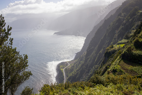 Madeira coastal cliffs overlooking the ocean. Scenic view with a winding road along the coast.