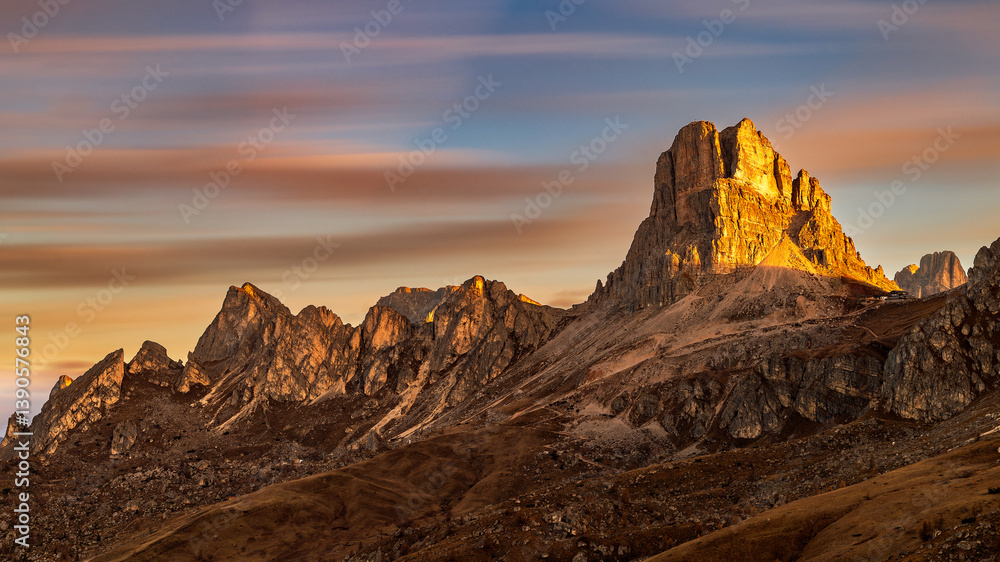 Naklejka premium The Passo di Giau mountain pass in the Italian Dolomites. Panoramic view of Passo di Giau at sunrise in autumn. View of the Ra Gusela mountain.
