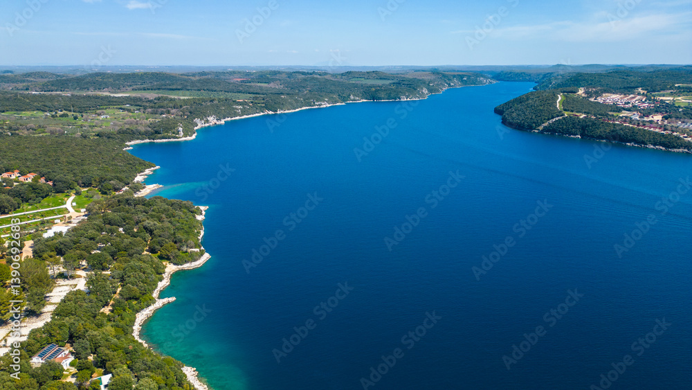Obraz premium Aerial photo of the stunning Limski Kanal and Camping Koversada near Vrsar, Croatia. The landscape features lush greenery, crystal-clear turquoise waters, and winding coastline — a true Adriatic