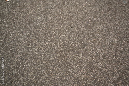 Fototapeta Naklejka Na Ścianę i Meble -  Asphalt road texture background. Close-up of gray rough street surface for design, architecture, and 3D rendering projects. Grunge road material with small stones and grainy structure.