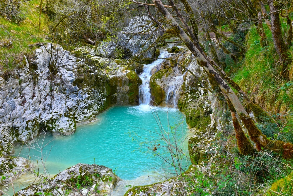 Waterfall at Buzet canyon flowing into a turquoise pool in Istria, Slovenia