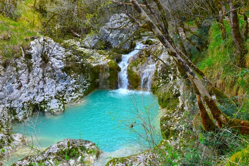 Waterfall at Buzet canyon flowing into a turquoise pool in Istria, Slovenia