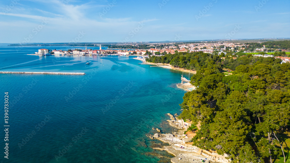 Aerial view of Poreč (Porec), Croatia, showcasing the charming old town, vibrant coastline, and the nearby island of Sveti Nikola. The stunning Zelena Laguna area adds to the beauty turquoise waters Aerial view of Poreč (Porec), Croatia, showcasing the charming old town, vibrant coastline, and the nearby island of Sveti Nikola. The stunning Zelena Laguna area adds to the beauty turquoise waters