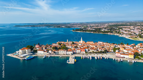 Aerial view of Poreč (Porec), Croatia, showcasing the charming old town, vibrant coastline, and the nearby island of Sveti Nikola. The stunning Zelena Laguna area adds to the beauty turquoise waters