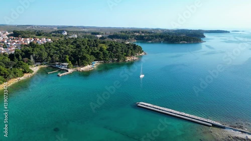 Aerial view of Poreč (Porec), Croatia, showcasing the charming old town, vibrant coastline, and the nearby island of Sveti Nikola. The stunning Zelena Laguna area adds to the beauty turquoise waters